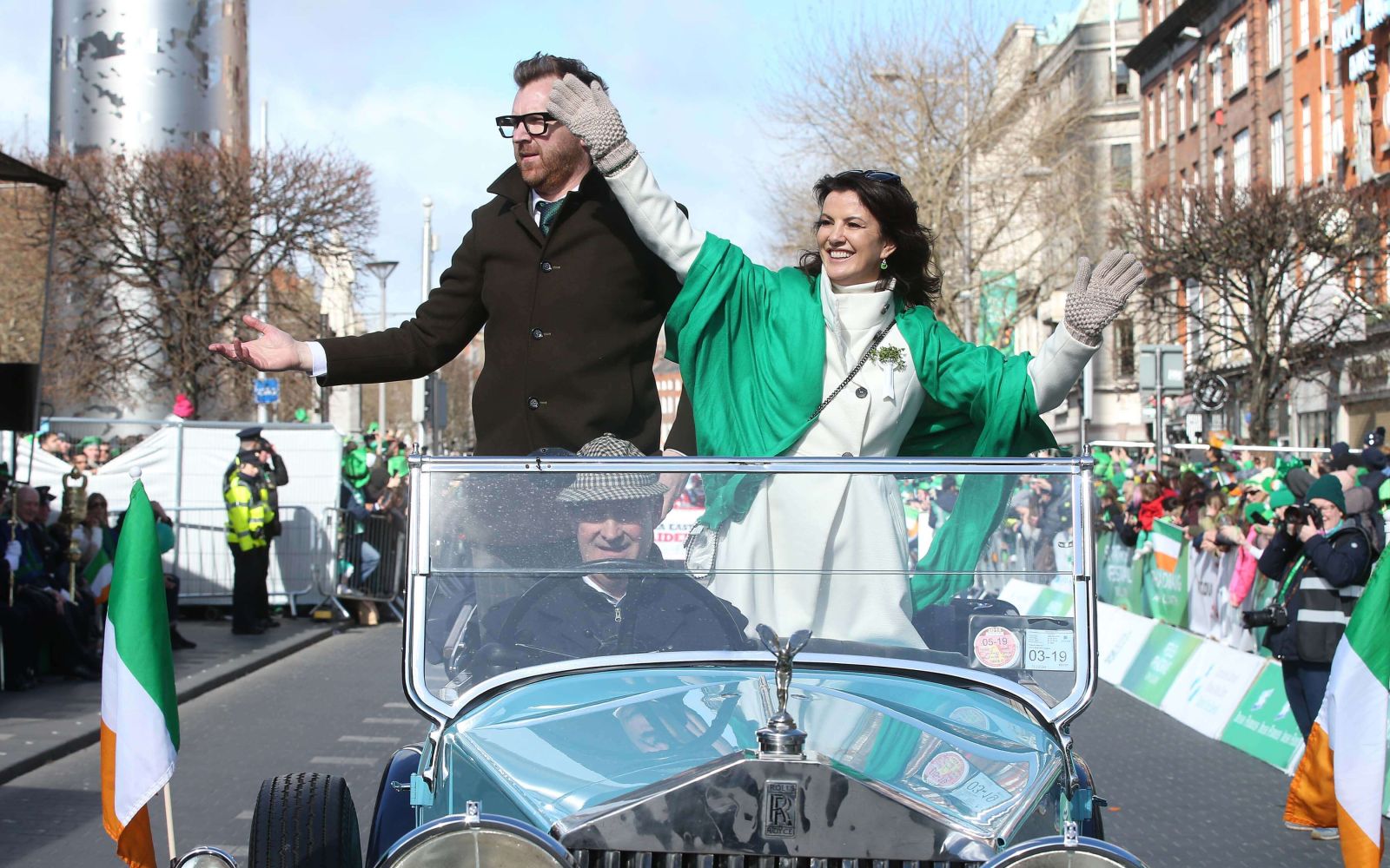 Grand Marshals waving and standing in convertible on oconnell street 2019 parade